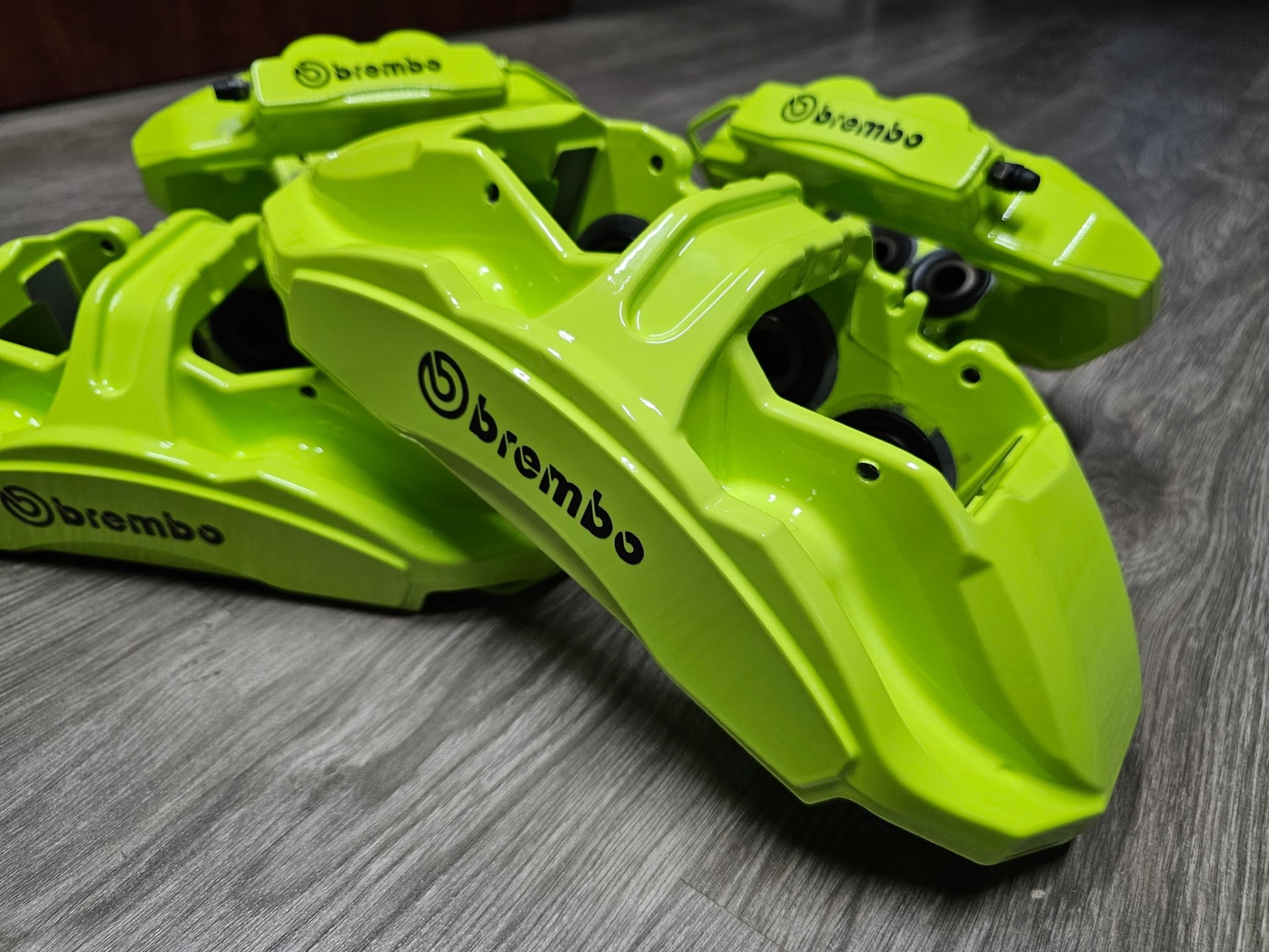 Powder coated red brake caliper after refinishing